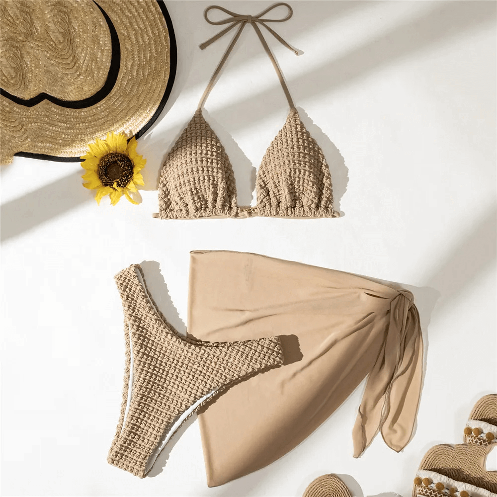 Neutral textured bikini set with halter top, cheeky bottoms, and matching sarong; perfect for chic beach style. SF2139